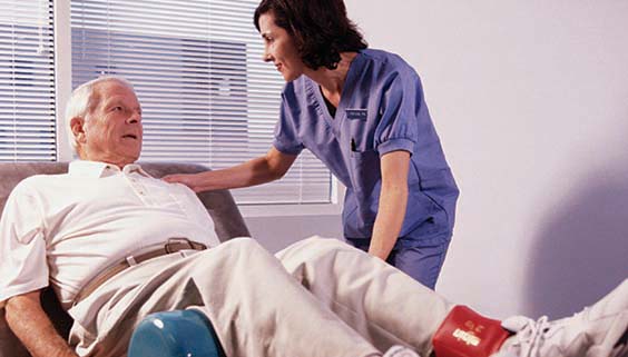 Side profile of a female nurse examining a patient